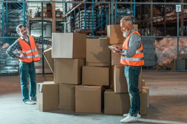 warehouse workers with digital tablet clipart