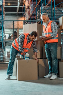 warehouse workers with digital tablet clipart