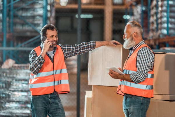 warehouse workers with digital devices