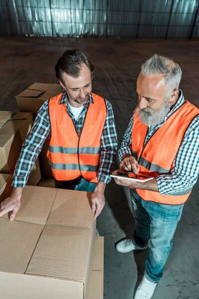 warehouse workers with digital tablet