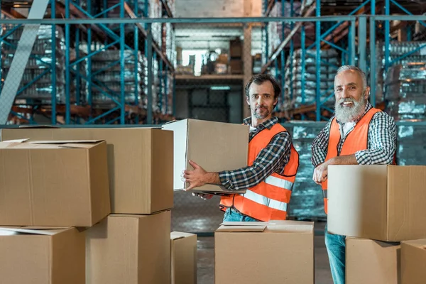 Warehouse workers with boxes — Stock Photo, Image