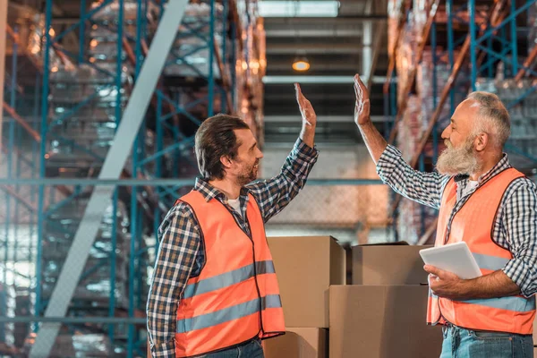 Warehouse workers with digital tablet Royalty Free Stock Photos