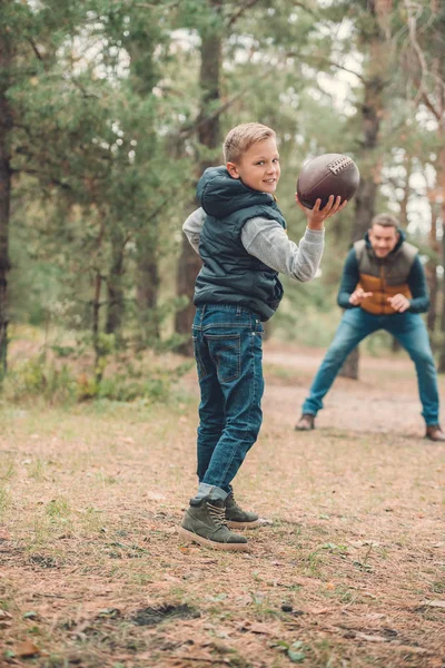 Father and son playing with ball in forest — Stock Photo, Image