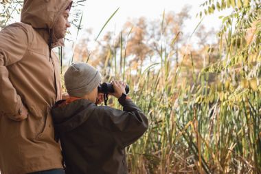 father and son with binoculars clipart