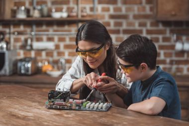 Mother and son soldering mothernoard clipart