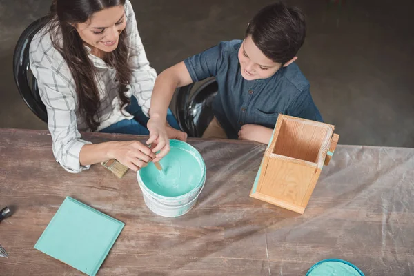 Son and mother painting birdhouse — Stock Photo, Image