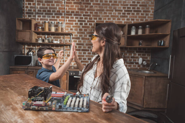 Mother and son high-fiving