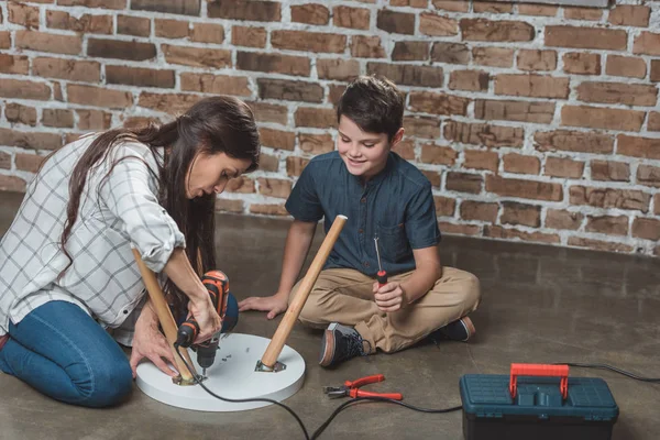 Mother and son assembling table — Stock Photo, Image