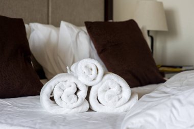 rolled towels on bed clipart