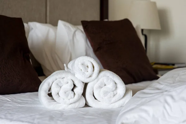 Rolled towels on bed — Stock Photo, Image