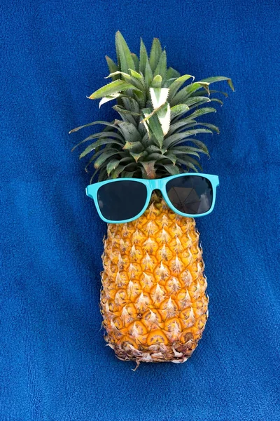 Pineapple in blue sunglassses — Stock Photo, Image