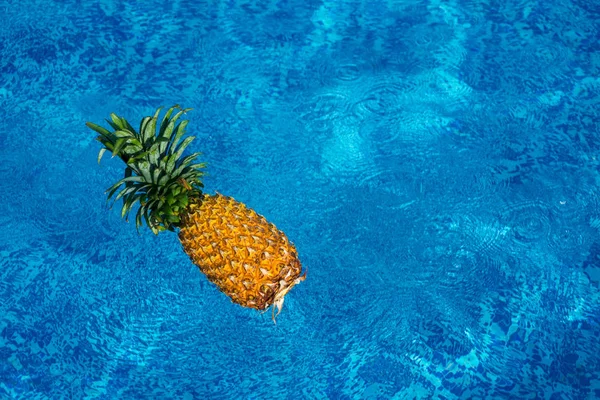 Pineapple floating in water — Stock Photo, Image