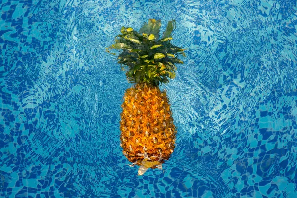Pineapple floating in water — Stock Photo, Image