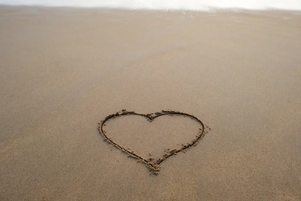 Heart shape sign on sand — Stock Photo, Image