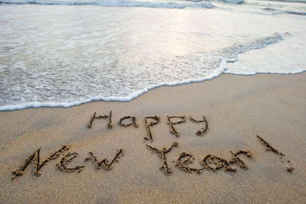 happy new year sign on beach