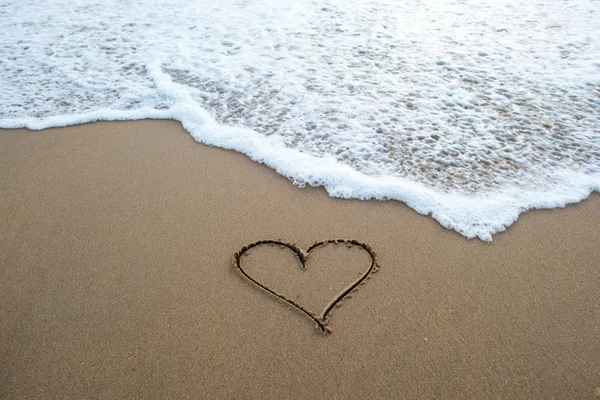 Heart shape sign on sand — Stock Photo, Image