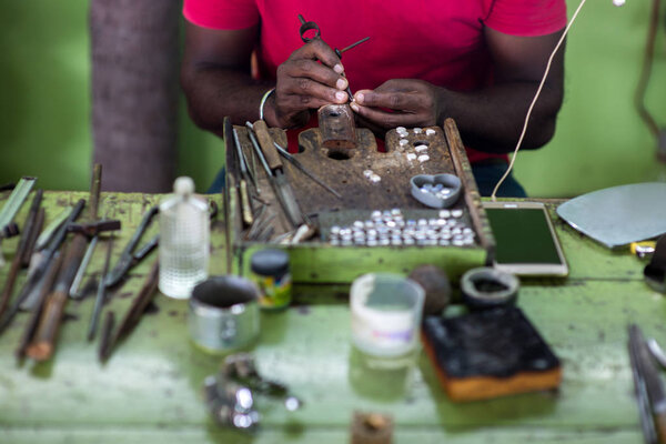 Cropped shot of oriental jeweler making rings at sri lanka manufacture