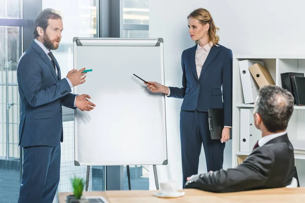 Lawyers pointing at white board — Stock Photo, Image