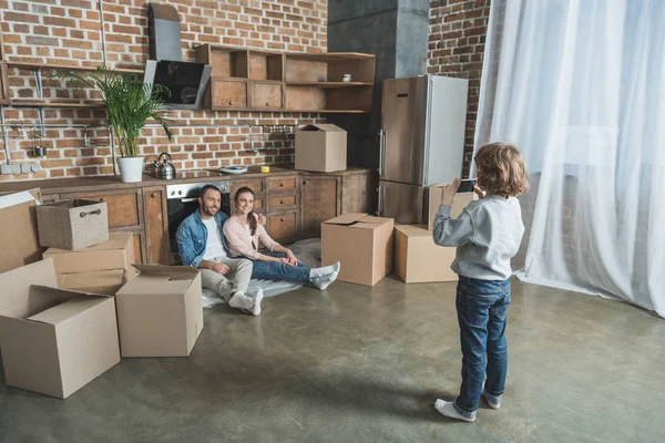 Little Boy Smartphone Photographing Parents While Moving Home Stock Picture