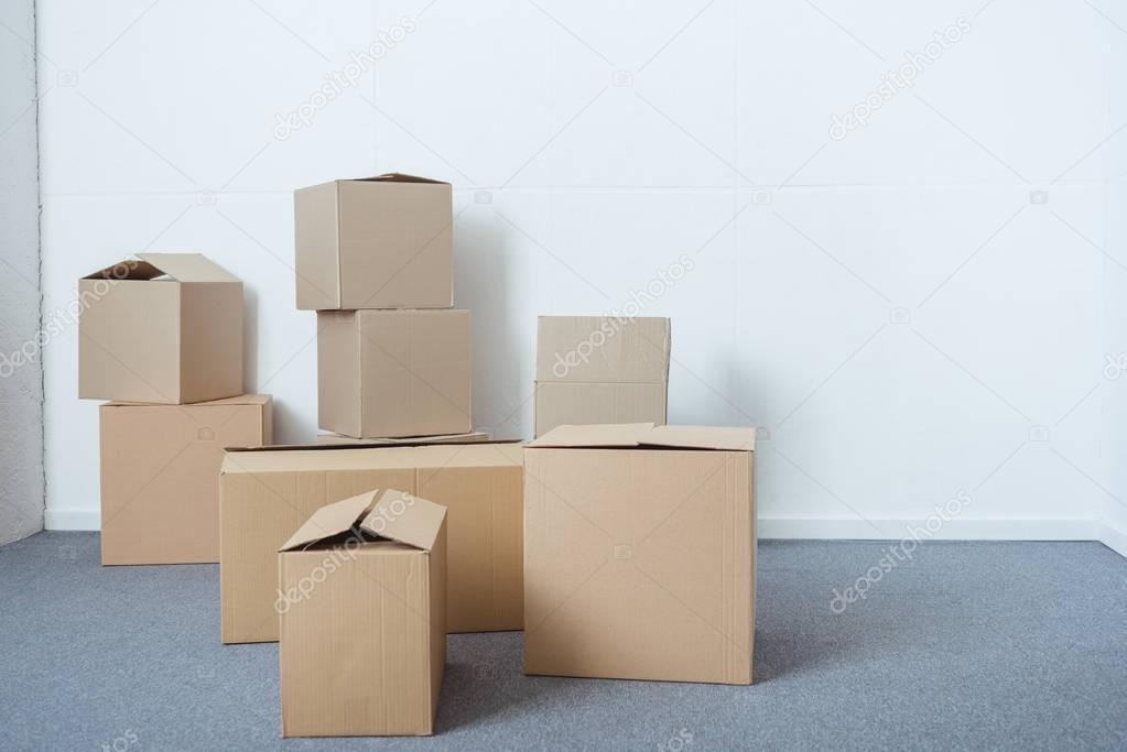 stacks of cardboard boxes in empty room during relocation