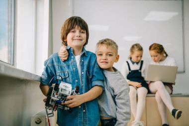 little kids with diy robot on machinery class clipart