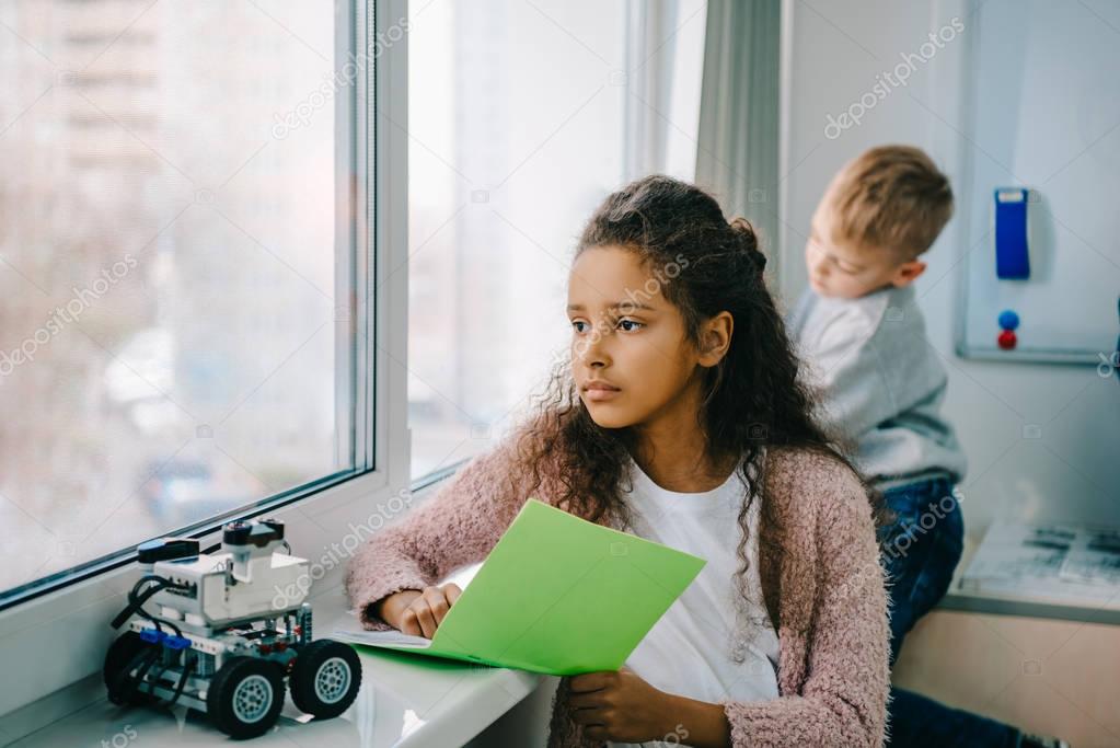 african american schoolgirl with notebook on stem education class