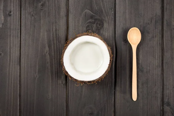 Ripe coconut with milk and spoon — Stock Photo