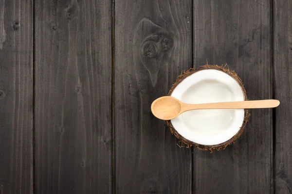 Ripe coconut with milk and spoon — Stock Photo
