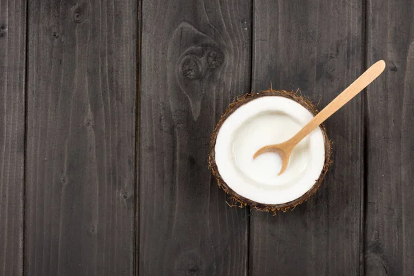 Ripe coconut with milk and spoon — Stock Photo