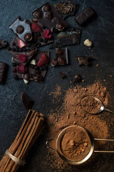 Pieces of chocolate with nuts and berries with cinnamon — Stock Photo