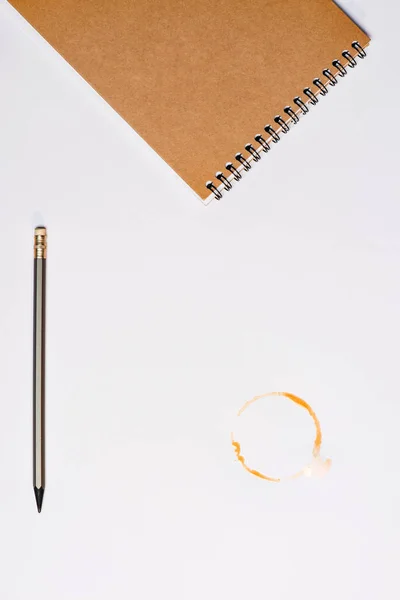 Notebook with pencil and coffee stain — Stock Photo