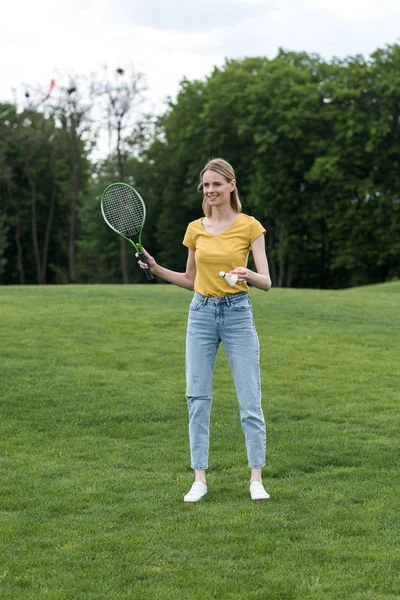 Woman with badminton racquet and shuttlecock — Stock Photo