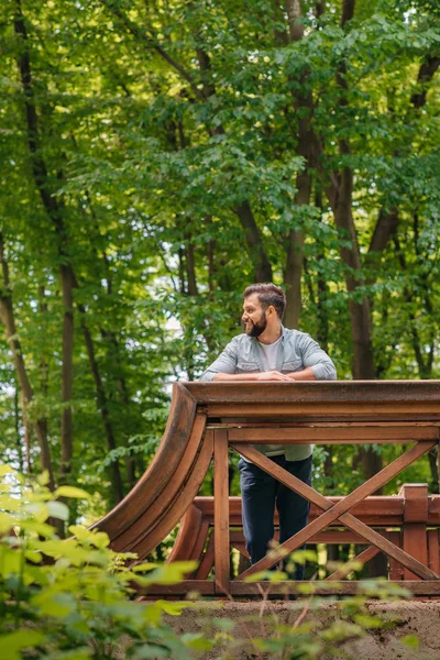 Man standing on wooden bridge — Stock Photo