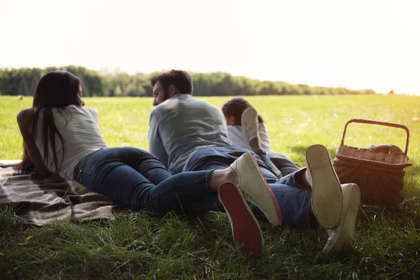 Family resting on blanket — Stock Photo