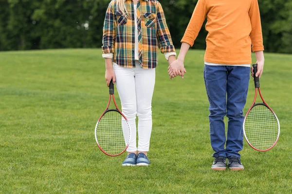 Kids with badminton racquets — Stock Photo