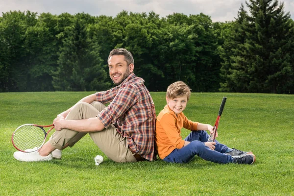 Family with badminton racquets — Stock Photo