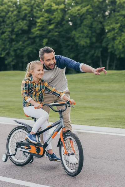 Family riding bicycle — Stock Photo