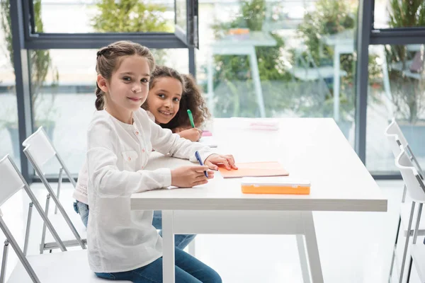 Multiethnic schoolgirls in classroom — Stock Photo