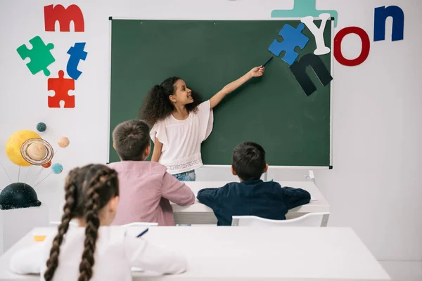 Schoolkids studying in classroom — Stock Photo