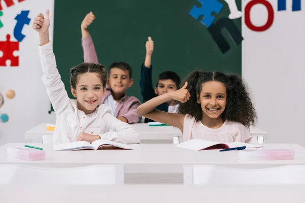 Multiethnic classmates with thumbs up — Stock Photo