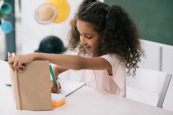 African american schoolgirl in classroom — Stock Photo