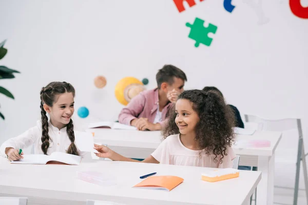 Multiethnic schoolgirls in classroom — Stock Photo