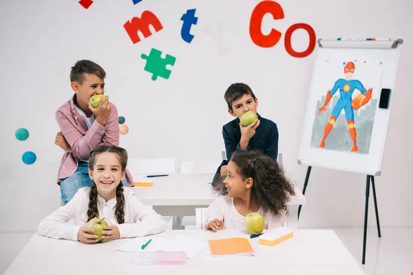 Pupils with apples at break — Stock Photo
