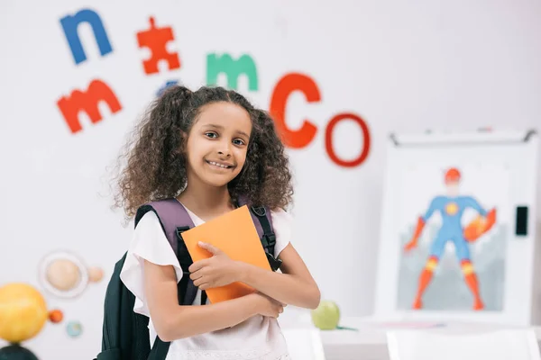 African american schoolgirl in classroom — Stock Photo