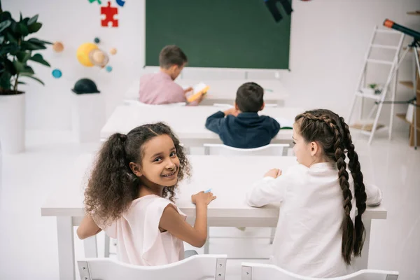 Schoolkids studying in classroom — Stock Photo