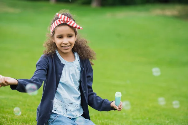 African american girl with soap bubbles — Stock Photo