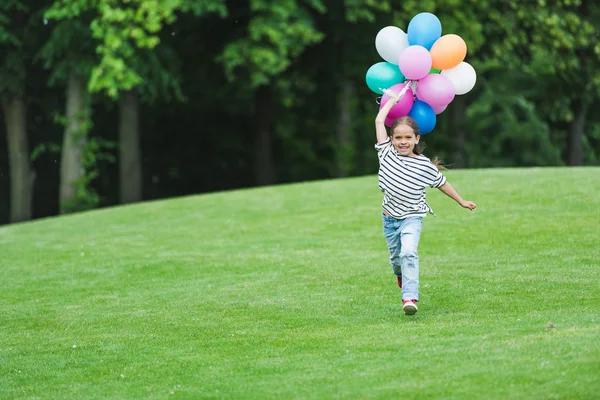 Girl with balloons in park — Stock Photo