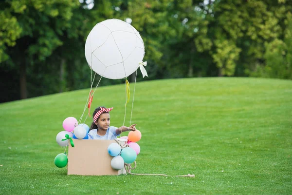 Girl in hot air balloon — Stock Photo