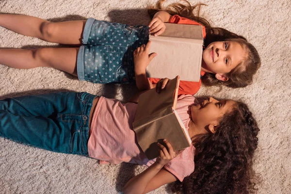 Chicas multiculturales tumbadas en el suelo - foto de stock