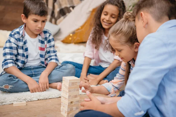 Children playing blocks wood game — Stock Photo